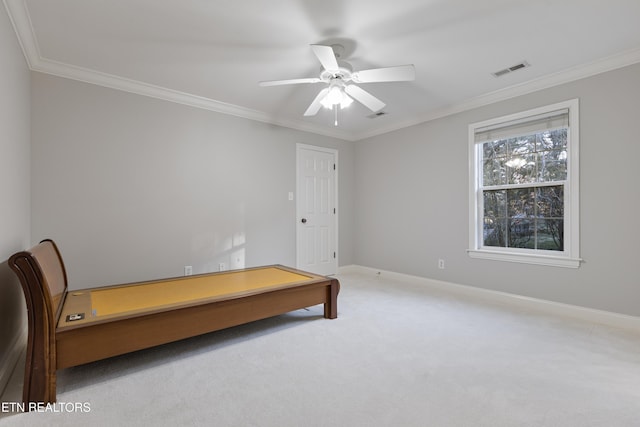 carpeted bedroom featuring crown molding, baseboards, and visible vents