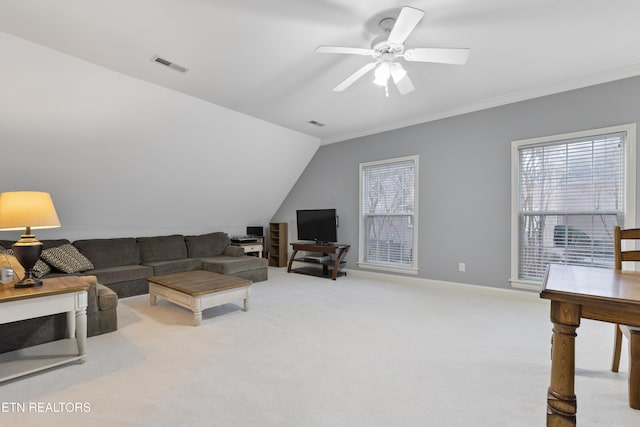 living room featuring visible vents, light carpet, a ceiling fan, crown molding, and baseboards