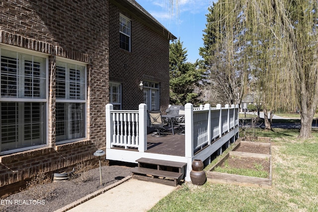 wooden terrace featuring a vegetable garden