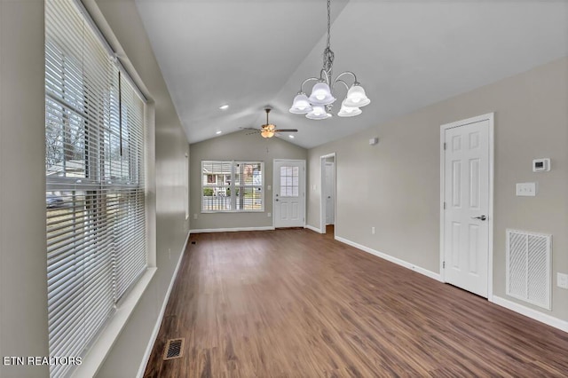 unfurnished room with visible vents, baseboards, dark wood-style flooring, and vaulted ceiling