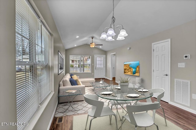 dining room featuring vaulted ceiling, wood finished floors, visible vents, and baseboards