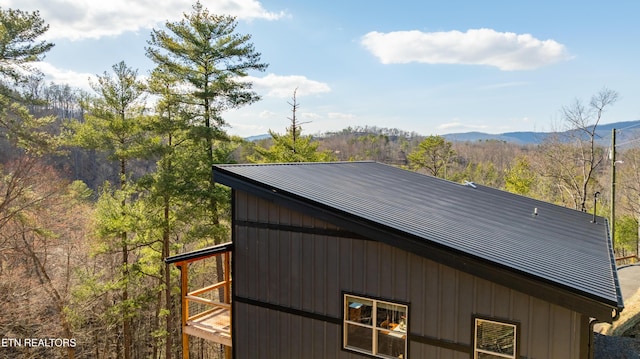 exterior space with a wooded view