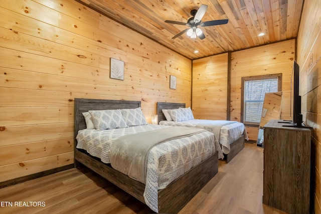 bedroom with wooden walls, recessed lighting, wood ceiling, and wood finished floors