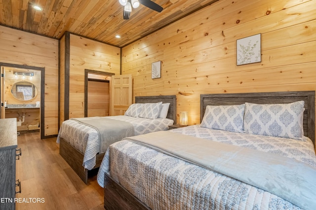 bedroom featuring wood finished floors, wooden walls, recessed lighting, and wood ceiling