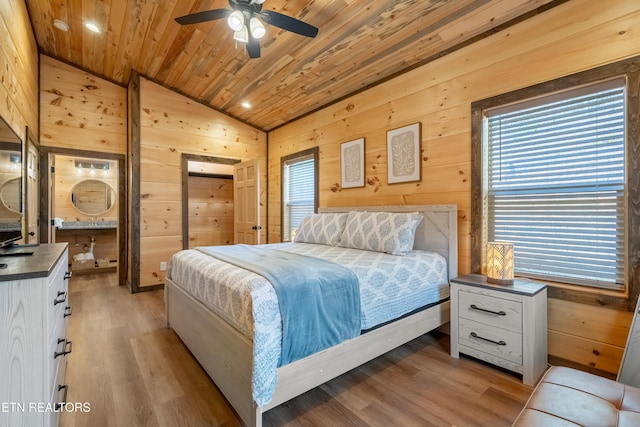 bedroom featuring light wood-style floors, wood ceiling, wood walls, and vaulted ceiling