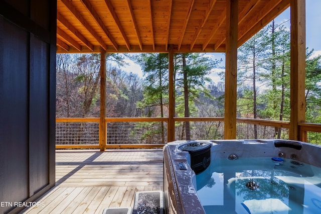 unfurnished sunroom with a wealth of natural light, wooden ceiling, and a hot tub