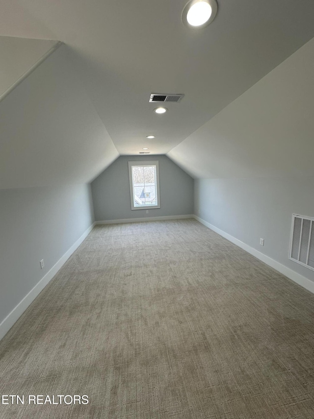 bonus room featuring vaulted ceiling, baseboards, and visible vents