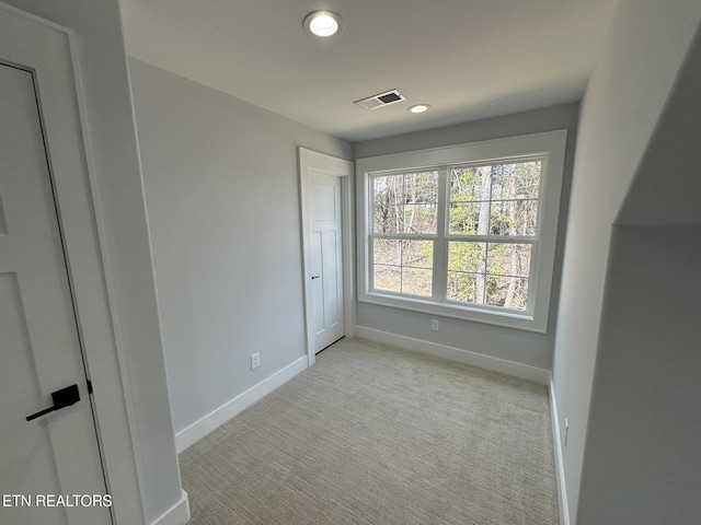 unfurnished bedroom with recessed lighting, light colored carpet, visible vents, and baseboards