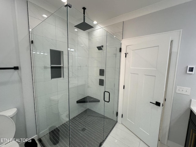 bathroom with vanity, toilet, and a stall shower