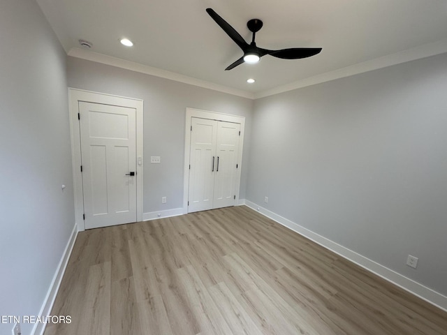 unfurnished bedroom featuring recessed lighting, baseboards, wood finished floors, and crown molding