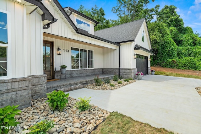 113 Nuhya Way, Loudon, TN 37774 - view of front of home with a porch, driveway, roof with shingles, board and batten siding, and a garage