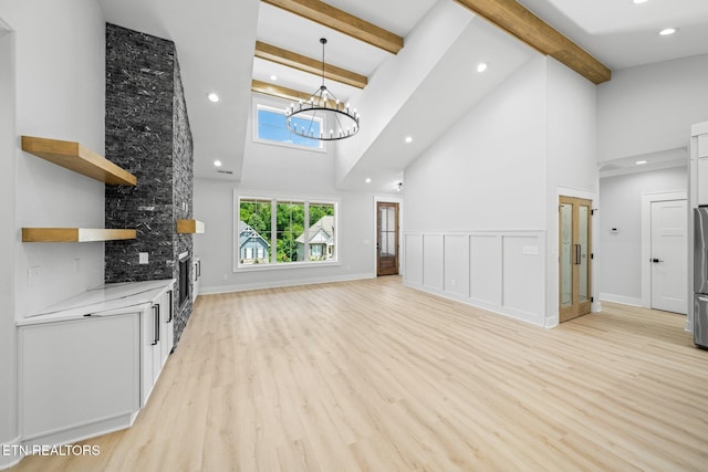 113 Nuhya Way, Loudon, TN 37774 - unfurnished living room featuring high vaulted ceiling, light wood-type flooring, beam ceiling, a chandelier, and recessed lighting