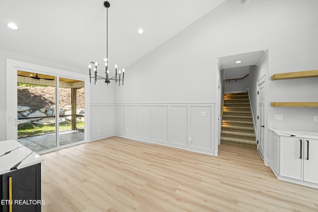 113 Nuhya Way, Loudon, TN 37774 - unfurnished dining area featuring light wood finished floors, high vaulted ceiling, a wainscoted wall, recessed lighting, and stairway