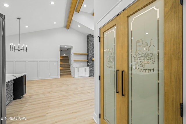 113 Nuhya Way, Loudon, TN 37774 - hall with light wood-style flooring, a chandelier, stairway, and wainscoting
