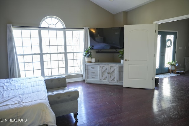 living area with plenty of natural light, wood finished floors, and vaulted ceiling