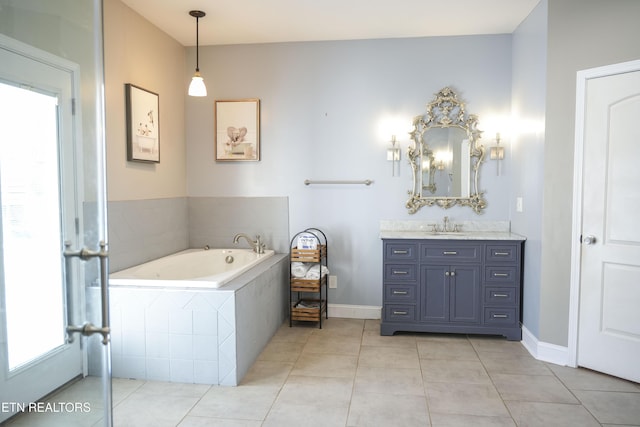 full bathroom with tile patterned flooring, a bath, vanity, and baseboards