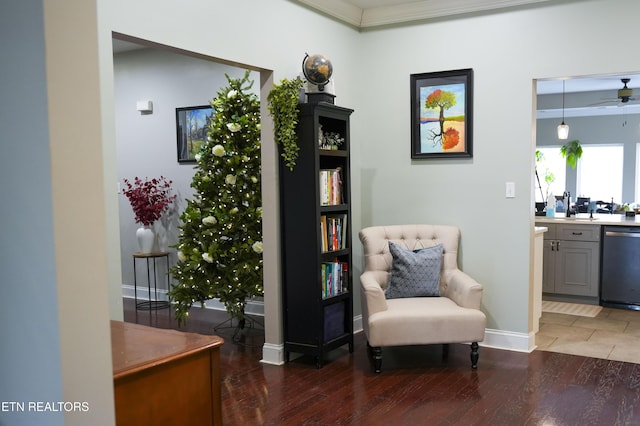 living area with baseboards and wood finished floors