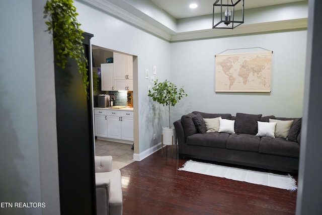 living area with baseboards and wood finished floors