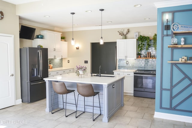 kitchen with ornamental molding, stainless steel appliances, light countertops, and a sink