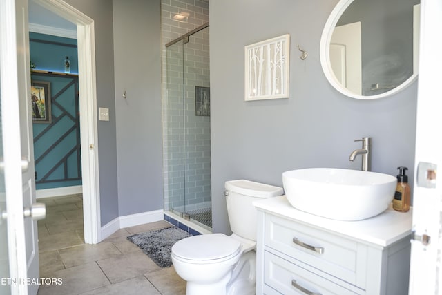 full bathroom featuring a shower stall, baseboards, toilet, tile patterned floors, and vanity