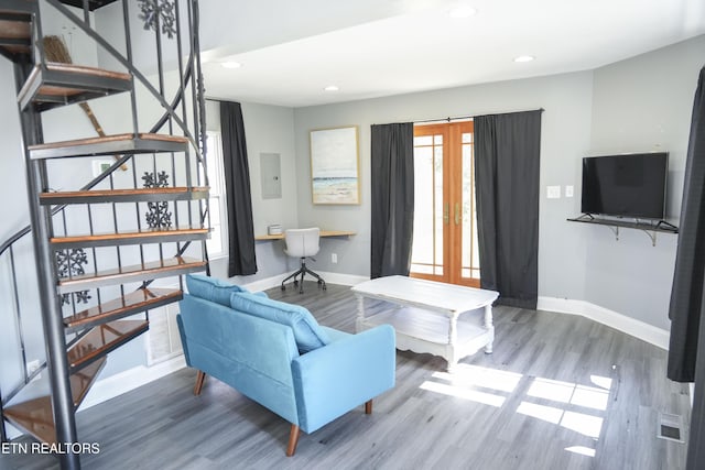 living room featuring wood finished floors, french doors, baseboards, and visible vents