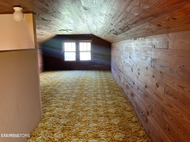 bonus room featuring wooden ceiling, wooden walls, carpet, and lofted ceiling