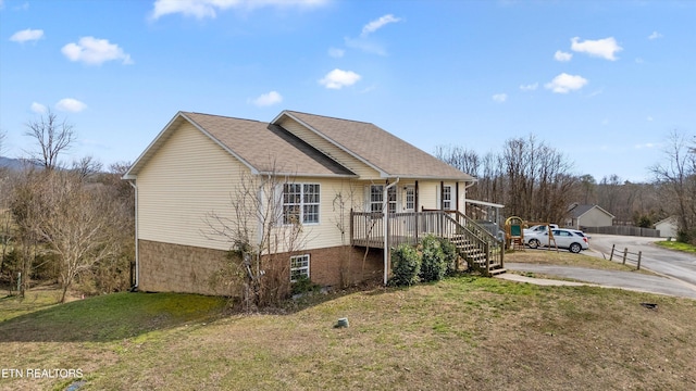 view of home's exterior featuring stairway and a lawn