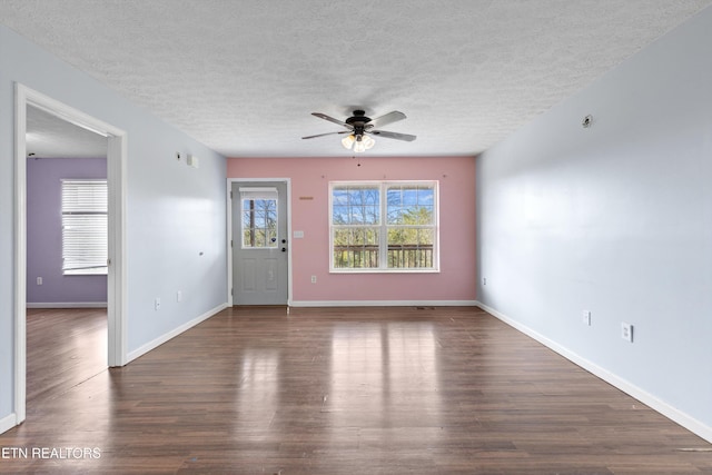 interior space with a textured ceiling, wood finished floors, baseboards, and ceiling fan