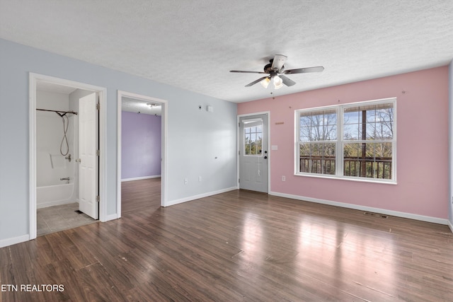 unfurnished living room featuring visible vents, baseboards, ceiling fan, wood finished floors, and a textured ceiling