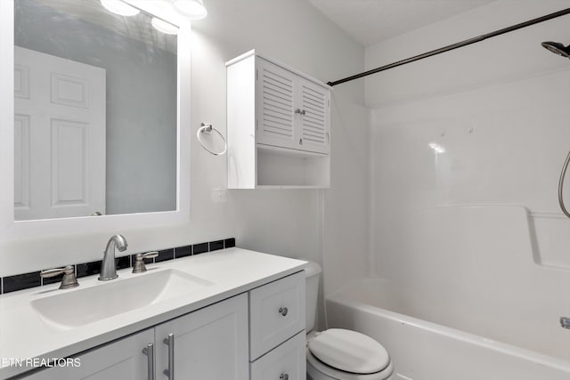 bathroom with shower / bath combination, toilet, and vanity