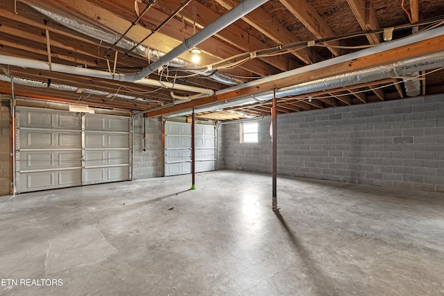 garage with concrete block wall