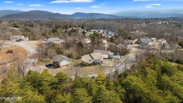 birds eye view of property featuring a mountain view and a forest view