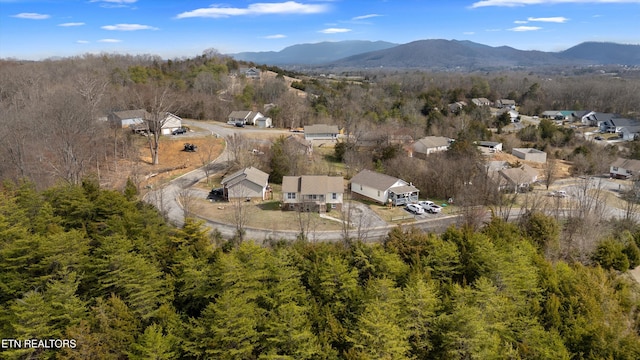 bird's eye view featuring a wooded view and a mountain view