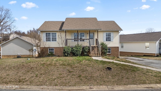 view of front of property featuring a porch, central AC, a front yard, brick siding, and stairs