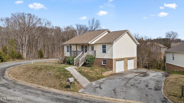 ranch-style house with a garage, roof with shingles, stairway, and aphalt driveway