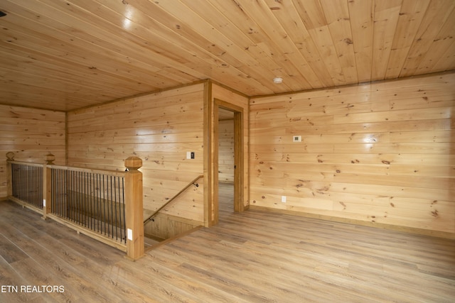 bonus room featuring a sauna, wooden ceiling, and wood finished floors