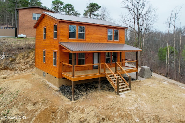 view of front of house featuring crawl space, metal roof, a porch, and stairs