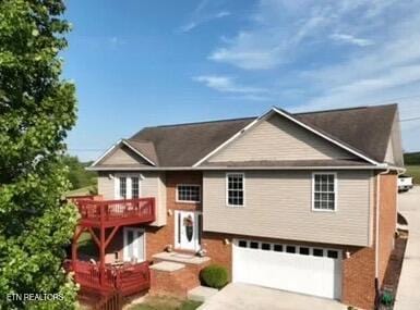 bi-level home featuring driveway and an attached garage