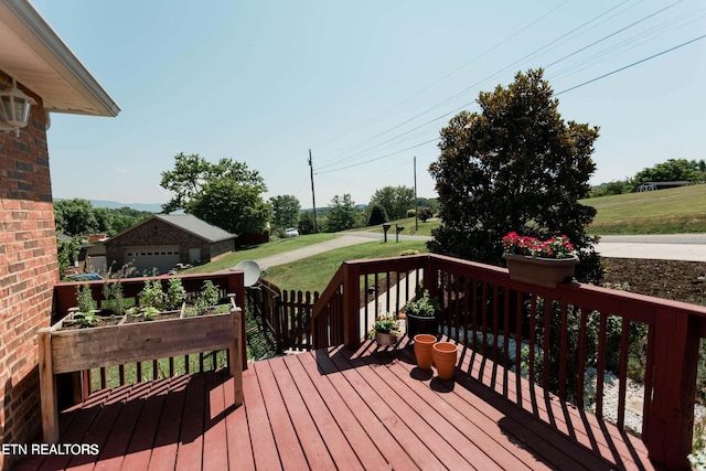 deck featuring an outdoor structure and a yard