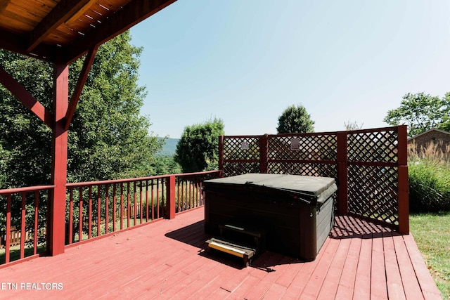 wooden deck featuring a hot tub