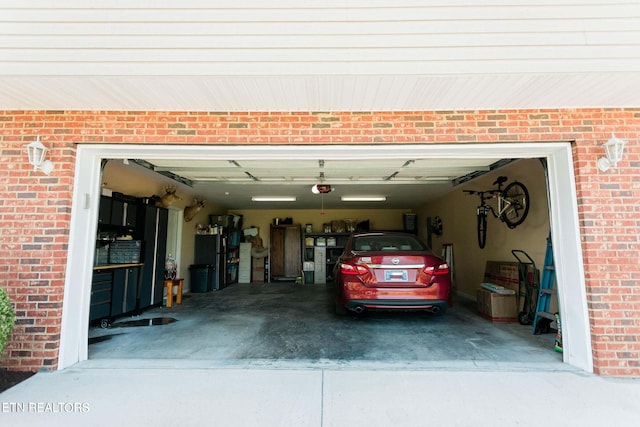 garage featuring a garage door opener and driveway