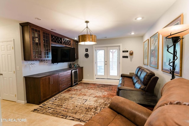 living area featuring beverage cooler, recessed lighting, french doors, light tile patterned flooring, and baseboards