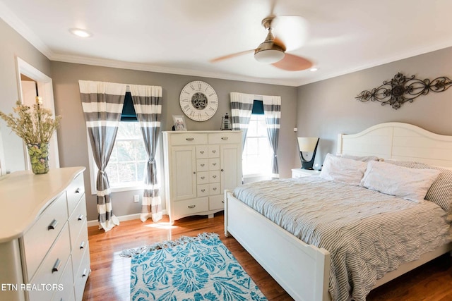 bedroom with ceiling fan, wood finished floors, baseboards, and ornamental molding