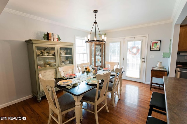 dining space with a chandelier, baseboards, wood finished floors, and ornamental molding