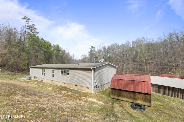 back of property with an outbuilding and crawl space