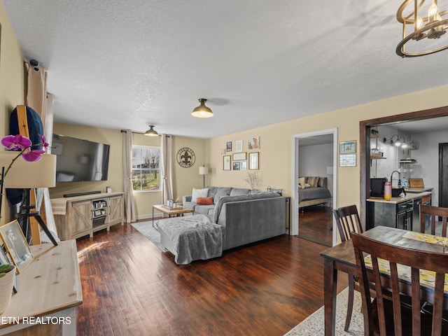 living room with dark wood-style floors and a textured ceiling