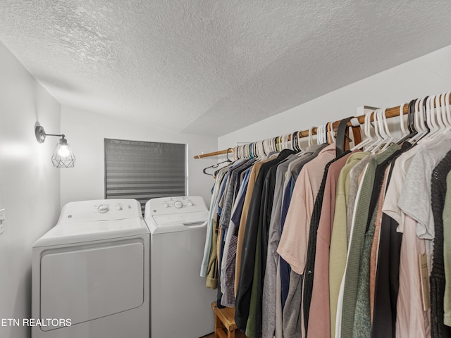 walk in closet with washing machine and dryer and vaulted ceiling