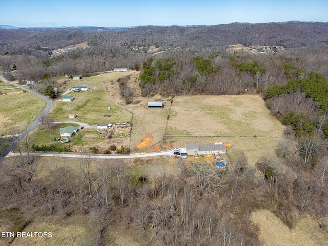 birds eye view of property featuring a rural view and a forest view