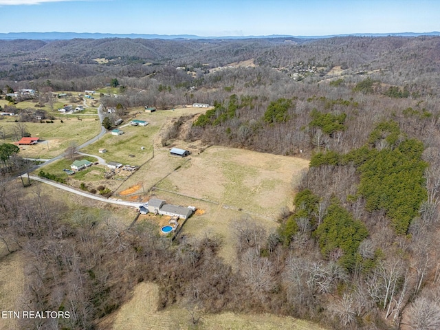 bird's eye view with a mountain view, a rural view, and a wooded view