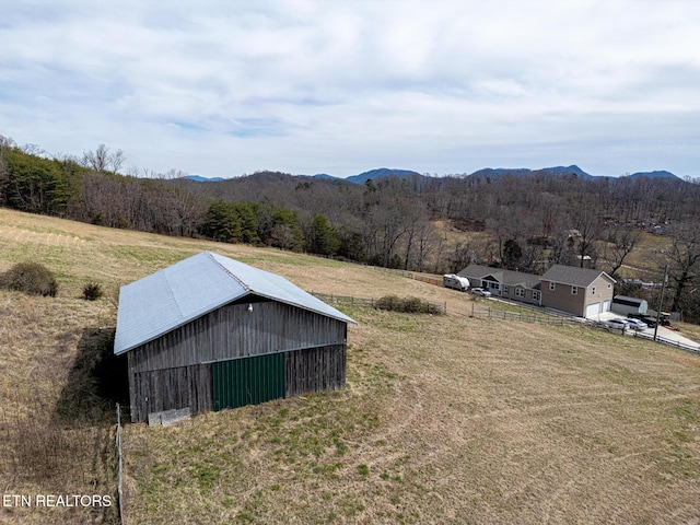 view of mountain feature with a view of trees and a rural view